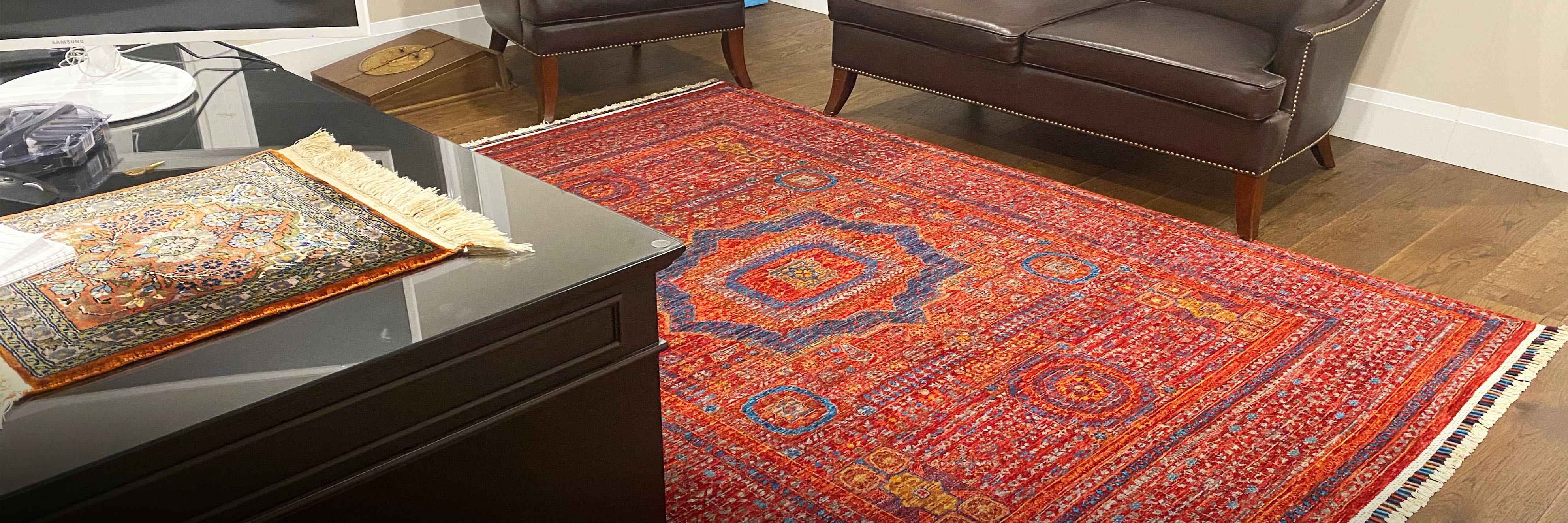 Rug on office floor between sofa and desk